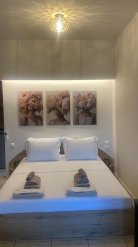 a bedroom with a bed with two pairs of shoes on it at Central studio D1 Volos in Volos