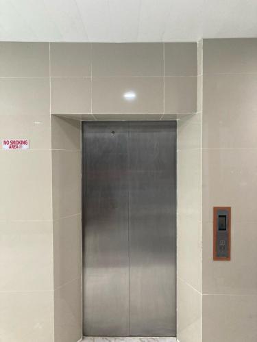 a elevator in a building with a silver door at Hotel Sanrina Kuta Bali in Kuta