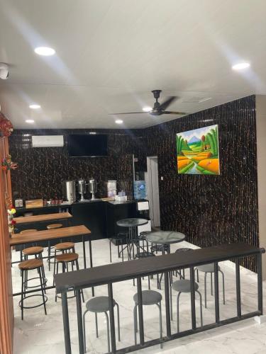 a restaurant with tables and chairs in a room at Hotel Sanrina Kuta Bali in Kuta