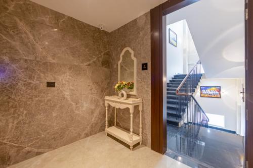 a bathroom with a sink and a staircase at Saltstayz Premier - Manesar & Sector 86 in Gurgaon