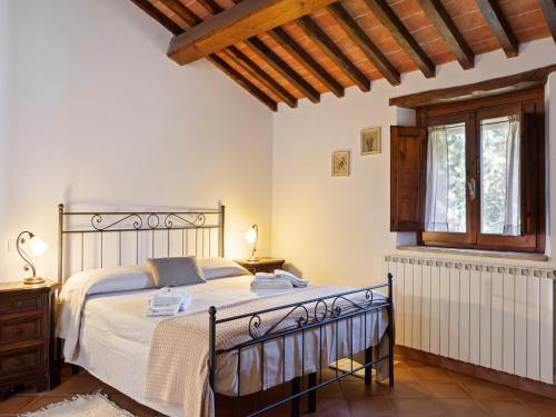 a bedroom with a bed and a window at Modern Holiday Home in Pietrafitta Umbria with Garden in Pietrafitta