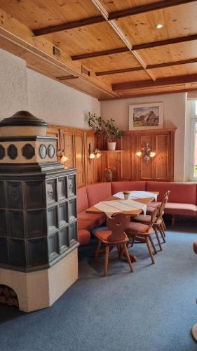 a kitchen with a stove and a table and chairs at Hotel Union Salzwedel in Salzwedel