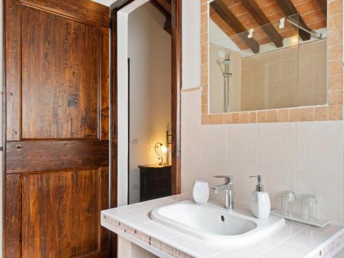 a bathroom with a sink and a mirror at Modern Holiday Home in Pietrafitta Umbria with Garden in Pietrafitta