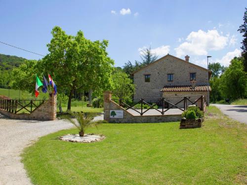 a house with a gate and flags in a yard at Modern Holiday Home in Pietrafitta Umbria with Garden in Pietrafitta