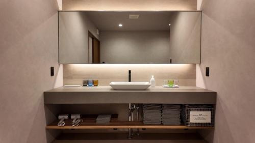 a bathroom with a sink and a mirror at SunVILLA EASTEND in Choshi