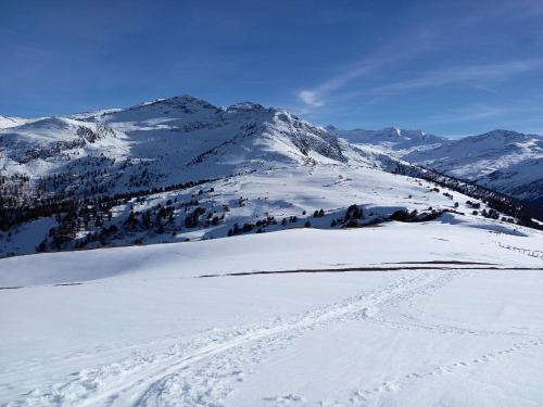 a snow covered mountain with ski tracks in the snow at High-quality holiday apartment in Oberkrimml near waterfalls in Krimml