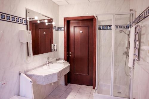 a bathroom with a sink and a shower at Park Hotel Diament Bielsko-Biała in Bielsko-Biala