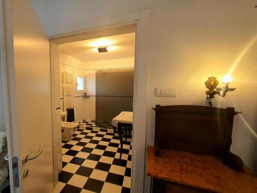 a hallway with a room with a checkered floor at Apartment in quiet and green environment with swimming pool in Modigliana