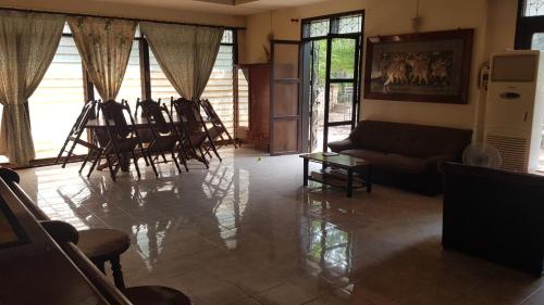 a living room with a lot of chairs and a couch at Danoopa homestay in Savannakhet