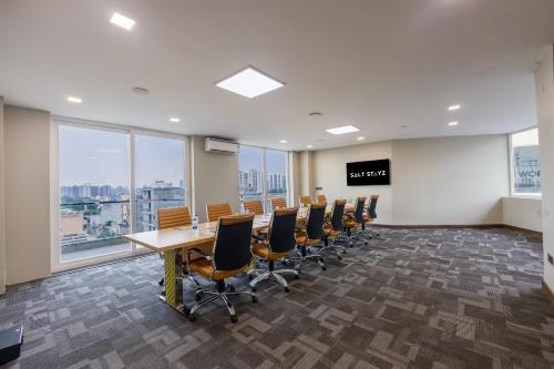 a conference room with a long table and chairs at Saltstayz Premier - Manesar & Sector 86 in Gurgaon
