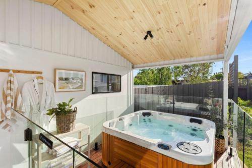 a jacuzzi tub in a room with a wooden ceiling at Sol Yarra Valley Barrel Sauna & Spa - Urban List in Yarra Glen