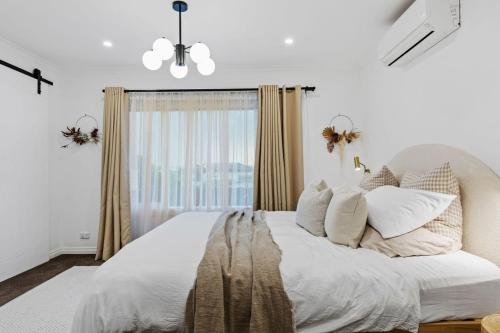 a bedroom with a large bed with a window at Sol Yarra Valley Barrel Sauna & Spa - Urban List in Yarra Glen