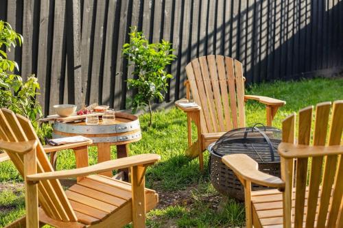 three chairs and a table and a grill in a yard at Sol Yarra Valley Barrel Sauna & Spa - Urban List in Yarra Glen