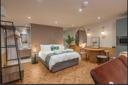 a hotel room with a bed and a bathroom at The Lodge Heaton Moor in Manchester