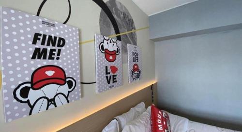 a bedroom with a shelf with stickers on the wall at Imin Hotel in Huadu
