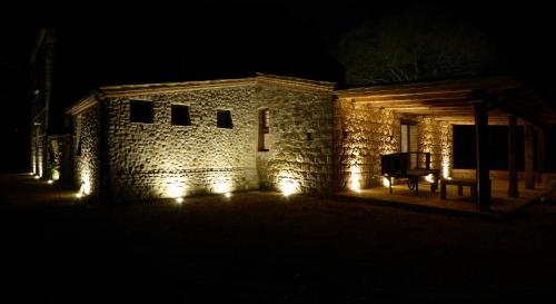 a stone building with lights on it at night at Pietre di Fiume in Apice