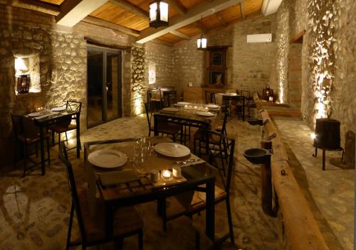 a restaurant with tables and chairs in a room at Pietre di Fiume in Apice