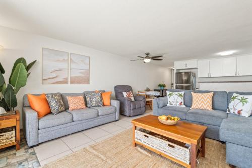 a living room with two couches and a table at Oceanfront Oasis - Calm Beach - Pool - AC in Hauula