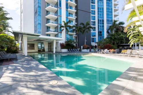 a swimming pool in front of a building at Artique Surfers Paradise - Official in Gold Coast