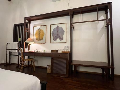 a bedroom with a desk and a bed and a bed at East Indies Mansion in George Town