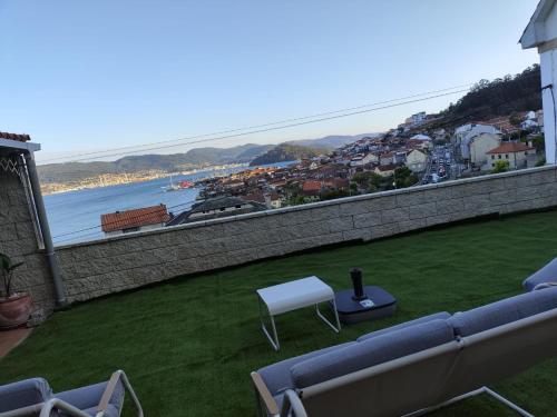 a balcony with a view of a body of water at Casa PEPE in Combarro