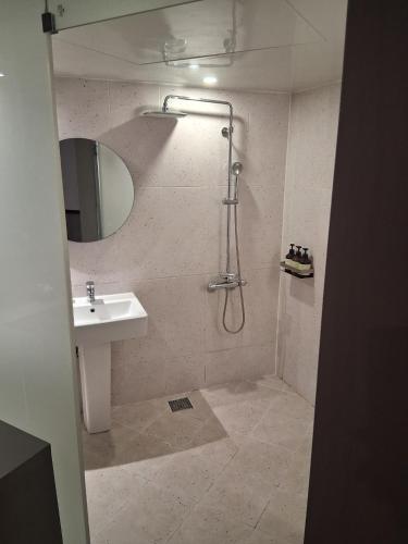 a bathroom with a shower and a sink at Aank Hotel Incheon Bupyeong in Incheon