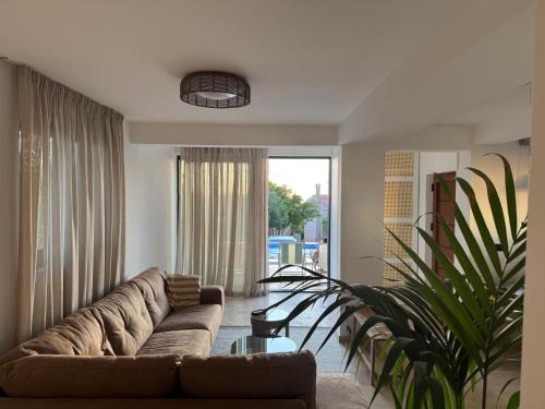 a living room with a couch and a plant at Casa del Sol Zagora in Zagora