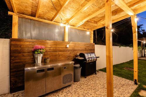 an outdoor kitchen with a wooden pergola at River Rest in Vetren