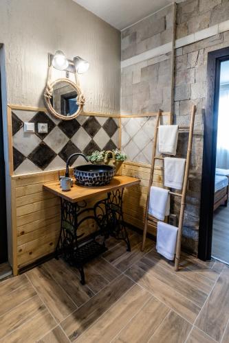a bathroom with a table and a mirror at River Rest in Vetren