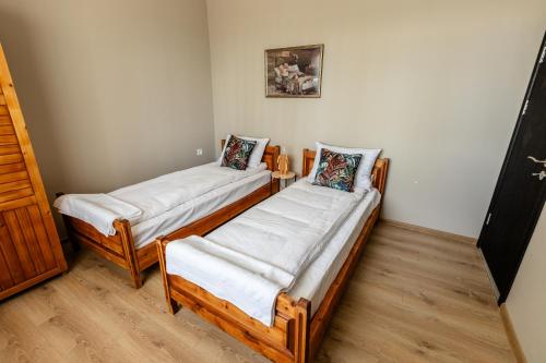 two wooden beds in a room with wooden floors at River Rest in Vetren