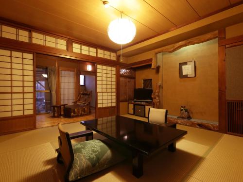 a living room with a table and chairs at Hanakanzashi in Nihommatsu