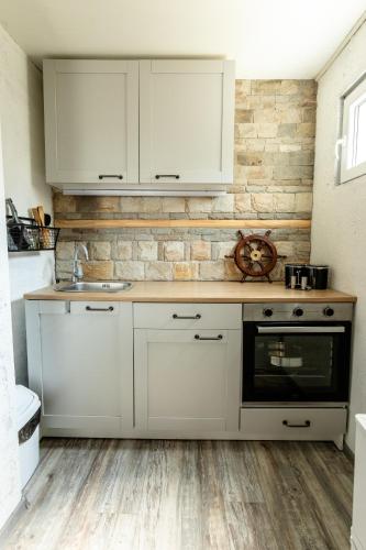 a kitchen with white cabinets and a sink at River Rest in Vetren