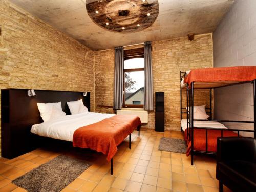a bedroom with a bed and a bunk bed at Fancy Holiday Home in Sainte-Cécile with Pool House & Indoor Pool in Sainte-Cécile