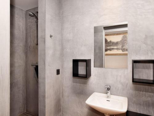 a bathroom with a sink and a shower at Fancy Holiday Home in Sainte-Cécile with Pool House & Indoor Pool in Sainte-Cécile