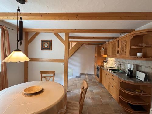 a kitchen with a wooden table in a room at Casa Armonia Halle- Ruhige Ferienwohnung am Pestalozzipark und Gesundbrunnen in Halle an der Saale