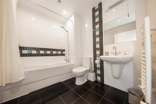a white bathroom with a toilet and a sink at Stunning and modern 2 bedroom apartment in Lucan in Lucan
