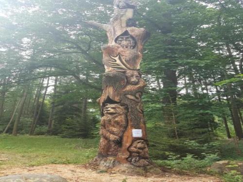 a totem pole in the middle of a forest at Comfortable Apartment in Nemojov near Forest in Horní Nemojov