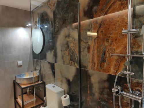 a bathroom with a shower with a glass wall at CORFU TENNIS Studios in Agios Rokkos