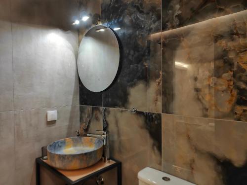a bathroom with a sink and a mirror at CORFU TENNIS Studios in Agios Rokkos