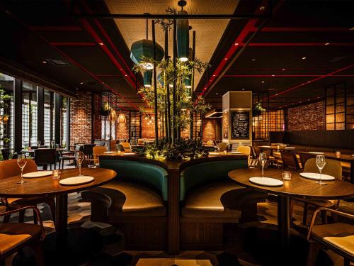 a restaurant with tables and chairs and a chandelier at Tokyo Bay Shiomi Prince Hotel in Tokyo