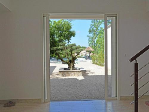 an open door with a view of a park at Modern Villa with Pool in Montauroux France in Montauroux