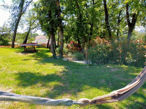 a hammock in a yard with a picnic table at Modern Villa with Pool in Montauroux France in Montauroux