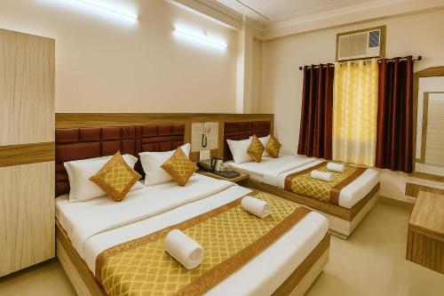 a hotel room with two beds in it at Hotel City Palace in Varanasi