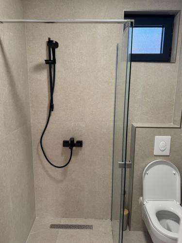a shower in a bathroom with a toilet at Casa del Sol Zagora in Zagora