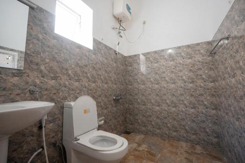 a bathroom with a toilet and a sink at Why Not Hostel in Mirissa