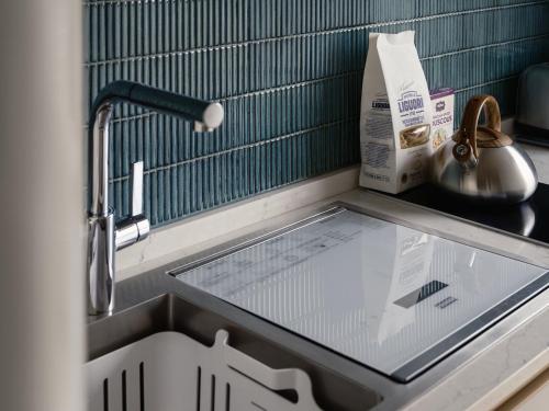 a kitchen counter with a sink with a glass window at North Bund 681 in Shanghai