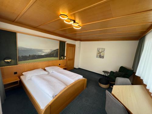 a bedroom with a large bed and a table at Kirchenwirt Sankt Aegidi in Sankt Aegidi