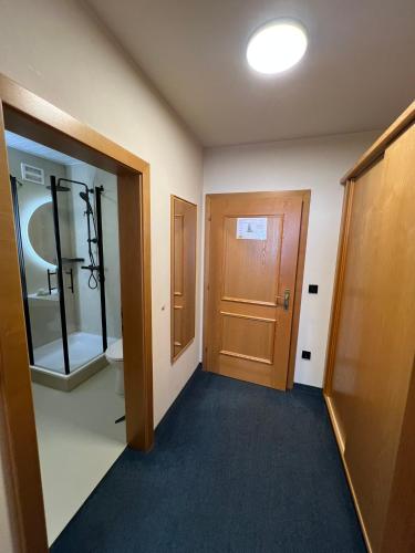 an empty room with a door and a hallway at Kirchenwirt Sankt Aegidi in Sankt Aegidi