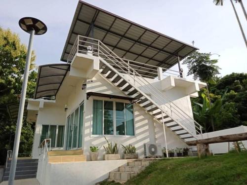 a house with a solarium on top of it at เฮือนป้อหลวง in Ban Fang