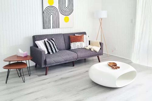 a living room with a couch and a coffee table at Beachfront Condo with Ocean View in Hauula